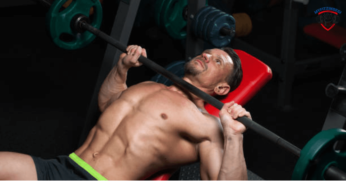 Man performing barbell bench press chest workout in gym for muscle growth